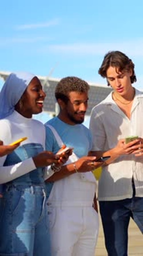Friends Smiling and Using Smartphones Together