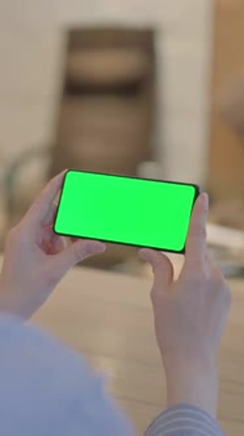 Young Woman Holding Phone with Chroma Key Screen, vertical video