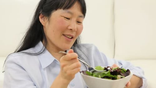 Woman Eating Salad in Home Interior Close Up