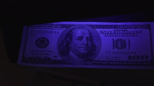 UV Light Shines on Hundred Dollar Bills