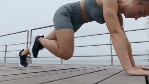 Young Woman Performing Mountain Climber Exercise for Abs