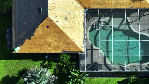Construction Workers Changing House Roof Covering Repair of Florida Home Removal of Old Asphalt