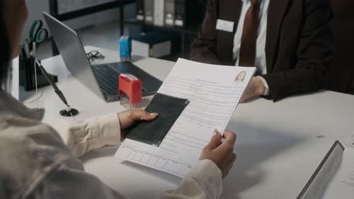 Female Embassy Officer Asking Visa Applicant Questions on Bank Statement