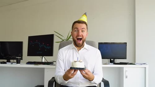 Happy Office Worker Celebrating Birthday at Workplace with Birthday Cake
