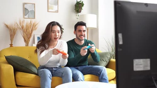 Couple Playing Video Games on the Couch