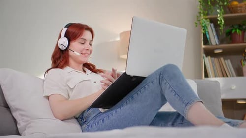 Freelance Work Young Beautiful Woman Works Online in a Call Center and Communicates with Client