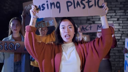 Group Protests Climate Change, Raising Signs