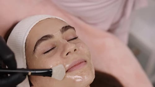 Woman Receiving Facial Mask Treatment at Spa