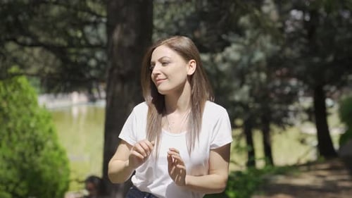 Woman Dancing Happily Outdoors in Sunny Park