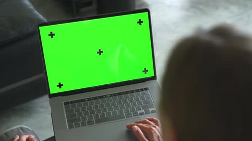 Green Screen laptop somputer. Woman wotking on laptop with Mock Up screen
