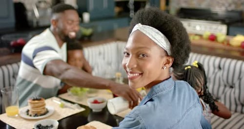 Happy Family Eating Breakfast Together at Home