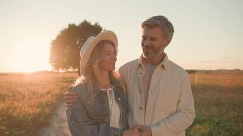 Loving Couple Embracing in Golden Field at Sunset