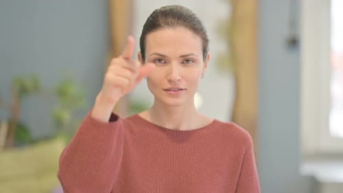 Woman Smiling and Pointing at the Camera