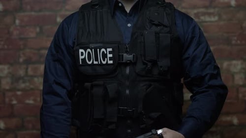 Officer Pulls Out Handgun in Front of Brick Wall