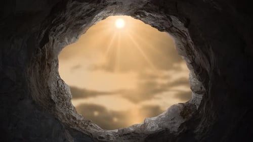 Cave Opening with Bright Sun Rays and Clouds