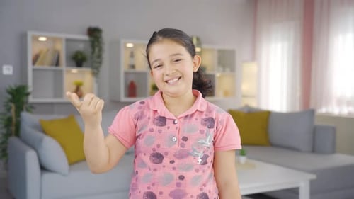 Girl child showing mind to camera.