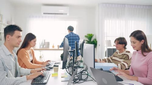 Group of young attractive business people working in office workplace.