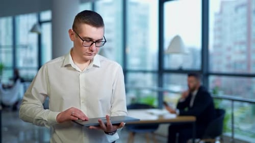 Young confident smart office worker. Handsome businessman working in the modern office.