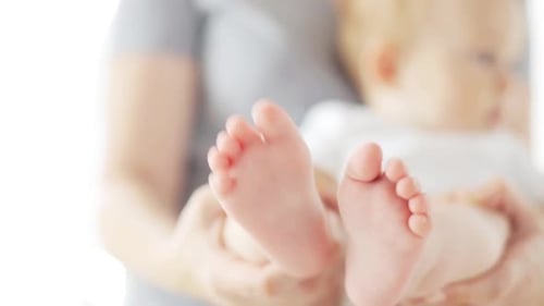 Baby's Feet in Mother's Hands, Close Up