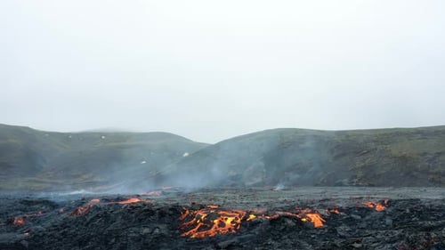 Exploding Volcano Crater With Hot Lava Flowing And Smoke Rising. Volcanic Eruption. aerial