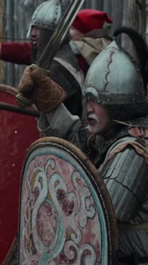 Men Holding Shields and Swords Wearing Medieval Armor