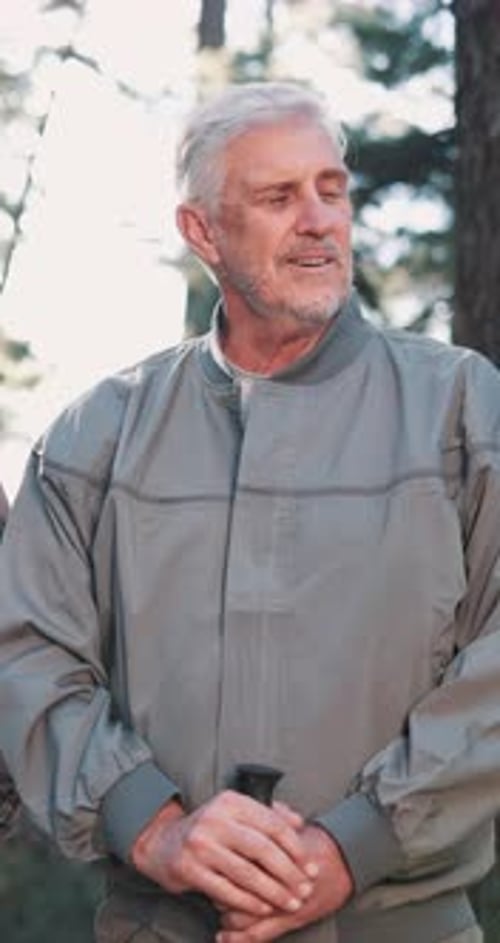 Hiking, laughing and talking with senior man outdoor in forest for exercise, hobby or recreation