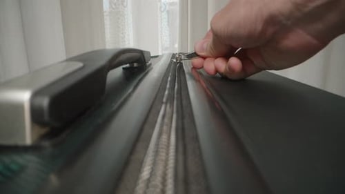 Dolly slider, close up. A Close-up of a zipper being closed, symbolizing the final step in packing