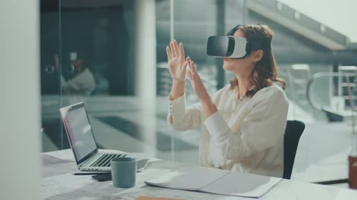 Woman Wearing VR Glasses Sits in a Bright Office Innovative Technologies