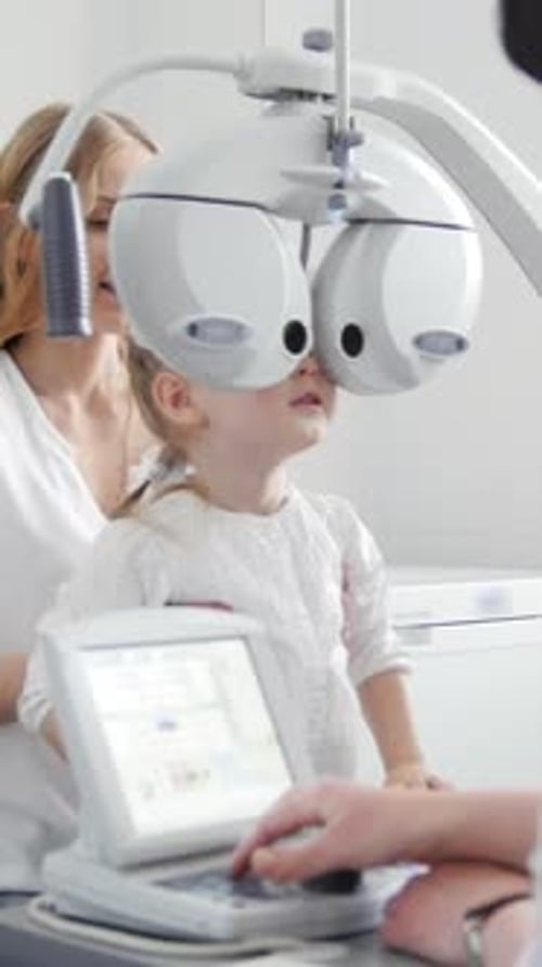 Children Ophthalmology Optometrist Checks Eye of Little Girl