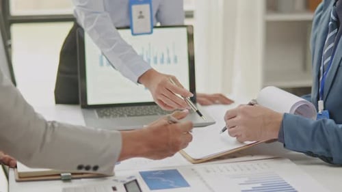 Nahaufnahme von Geschäftspartnern, die an Papierkram arbeiten und Brainstorming machen.