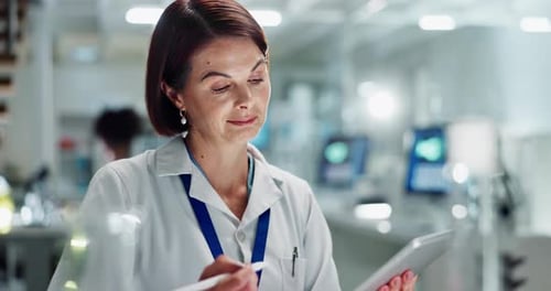 Woman Working in Lab Using Tablet