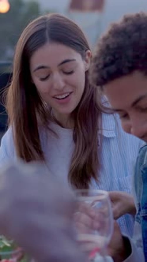 Young Group of Friends Having Barbecue Dinner Party at Terrace Rooftop in Summer