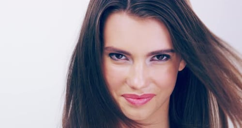 Glamorous Woman Smiling with Hair Blowing in the Wind