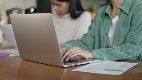 Adults Working at Home on Laptops