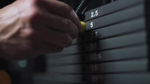 Anonymous Athlete Sportsman Chooses the Weight on the Gym Machine Taking Weight Lifting in Sport