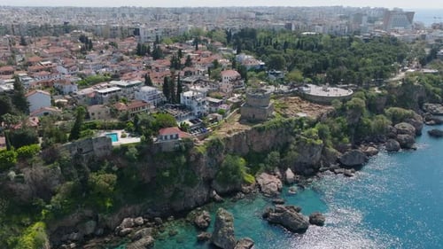 Beautiful Aerial Footage of Sea Coast in City Clear Blue Water Reflecting Sun Rays Under Rocky Cliff