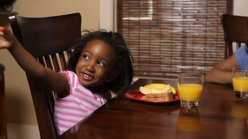 Girl eating breakfast at the kitchen table