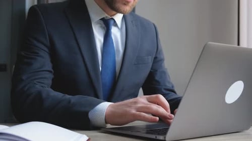 Closeup of an Office Worker Working on a Laptop