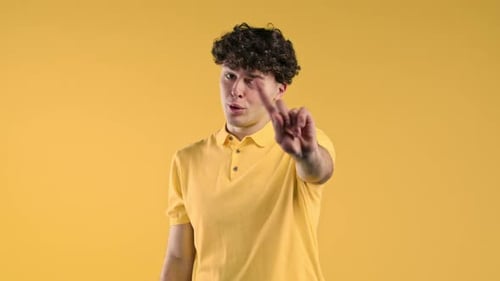 Young Adult Makes No Gesture on Yellow Background