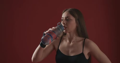 Fit Woman Drinking Water After Exercise