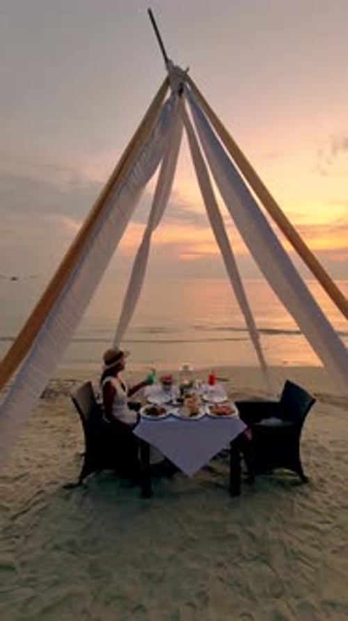 Asian Thai Women Having a Romantic Dinner on the Beach of Koh Chang in Thailand During Sunset