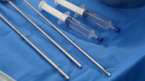 Surgical instruments for liposuction on the sterile table of an operating room. Close up.