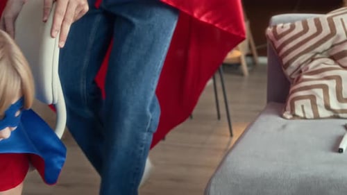 Boy Dressed as Superhero Pretends to Fly