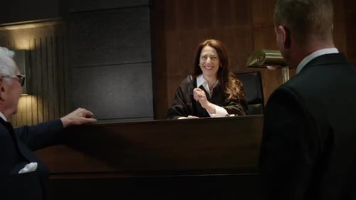 Judge smiling and laughing in court with lawyers legal scene