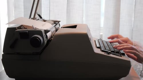 Typewriter. Woman typing on old vintage retro typewriter, fingers press keys