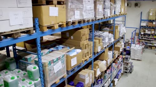 Slow jib shot moving down of Food, Grocery and Households warehouse in Italy. Shelves full of stock