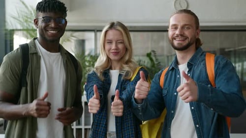 Cheerful Young Adults Giving Thumbs Up Together