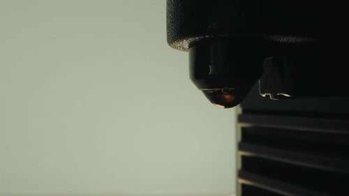 Close-up of coffee drip forming from nozzle, capturing the brewing process