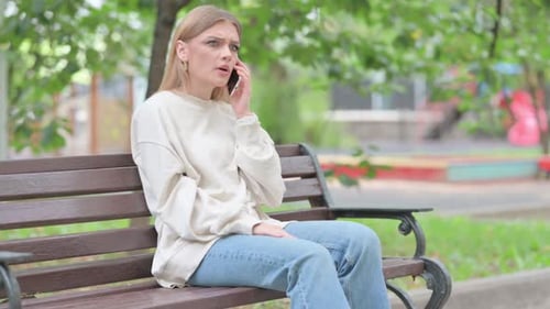 Woman Talking on Phone on Park Bench