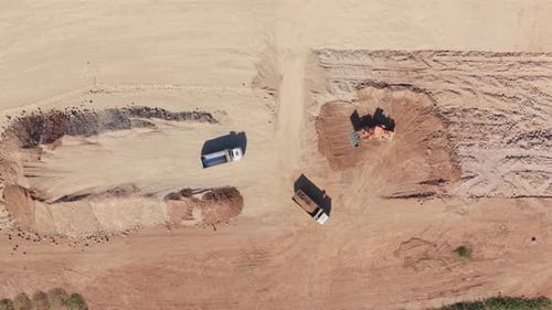 Aerial view of bulldozer loading a dump truck at a construction site